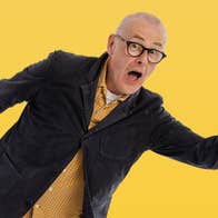 A man with surprised look on face with mouth wide open and arms outstretched, against bright yellow background.