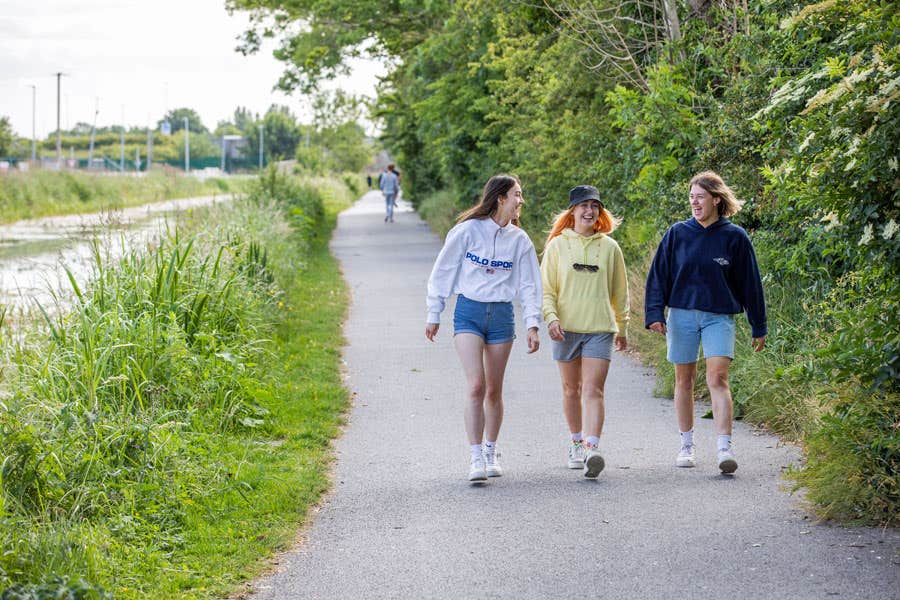 Three friends walking along the pathway of the Royal Canal Greenway