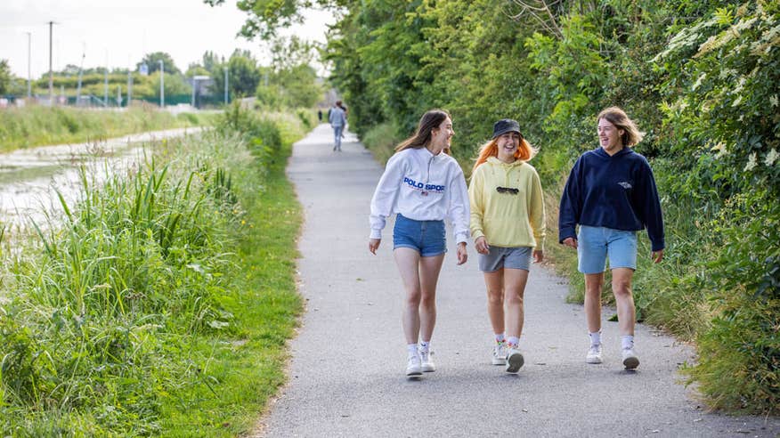 Three friends walking along the pathway of the Royal Canal Greenway