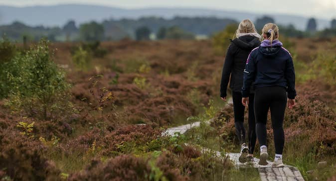Two women walking the Laghile and Loughan Loop walk in Scohaboy Bog, County Tipperary