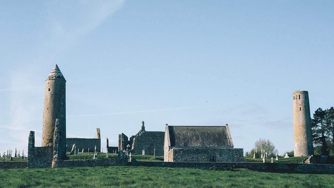 Towers and old buildings in a field at Clonmacnoise in Offaly