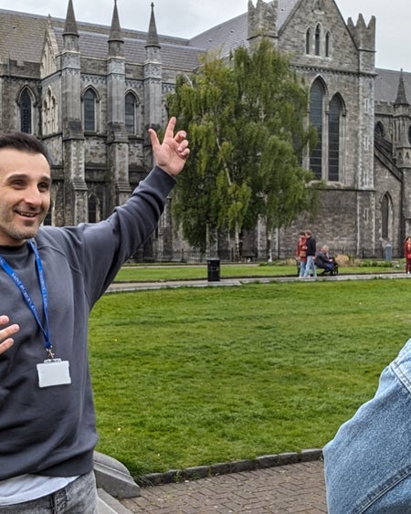 Tour guide pointing at church