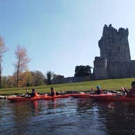 A group of kayakers starting their tour at Ross Castle with Killarney Lakes Kayaking Tours
