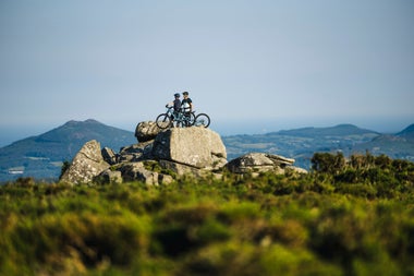 Two people with mountain bikes on Ticknock mountain