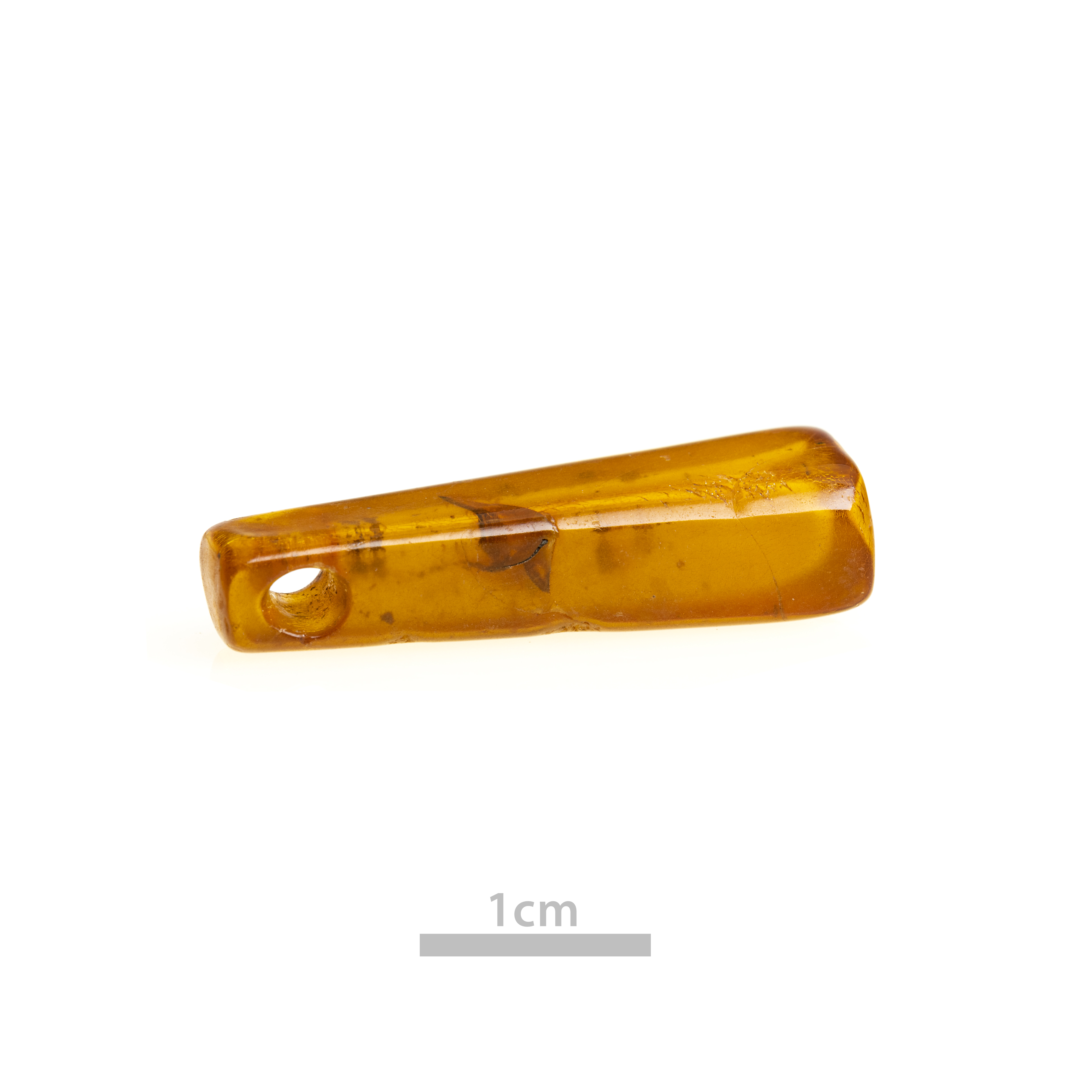 Small, amber coloured, tall, slim bead with hole at one end, against plain white background.