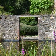 Old mill wall and pond at Fairbrook House Garden