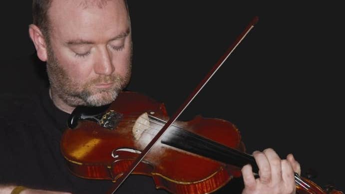 Fiddle player MacDara Ó Raghallaigh, playing a fiddle