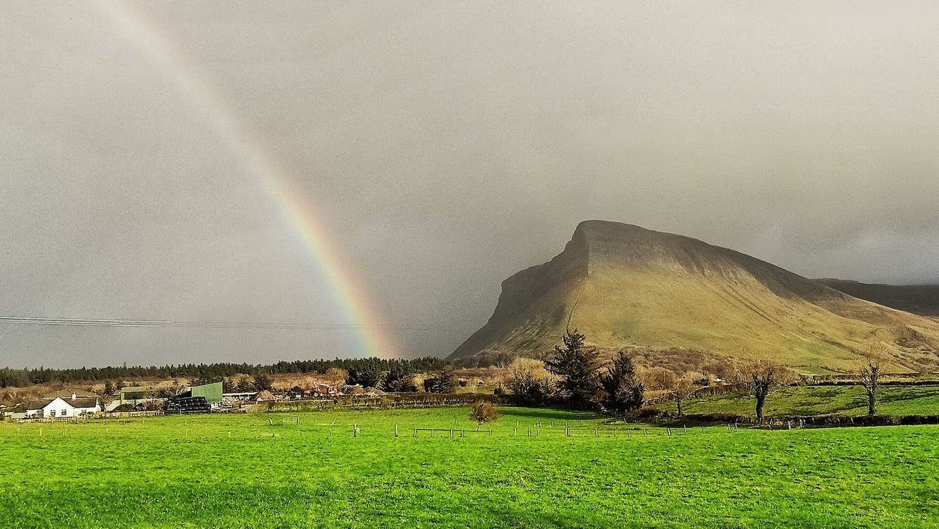 Grey sky with a rainbow near Benbulben in Sligo