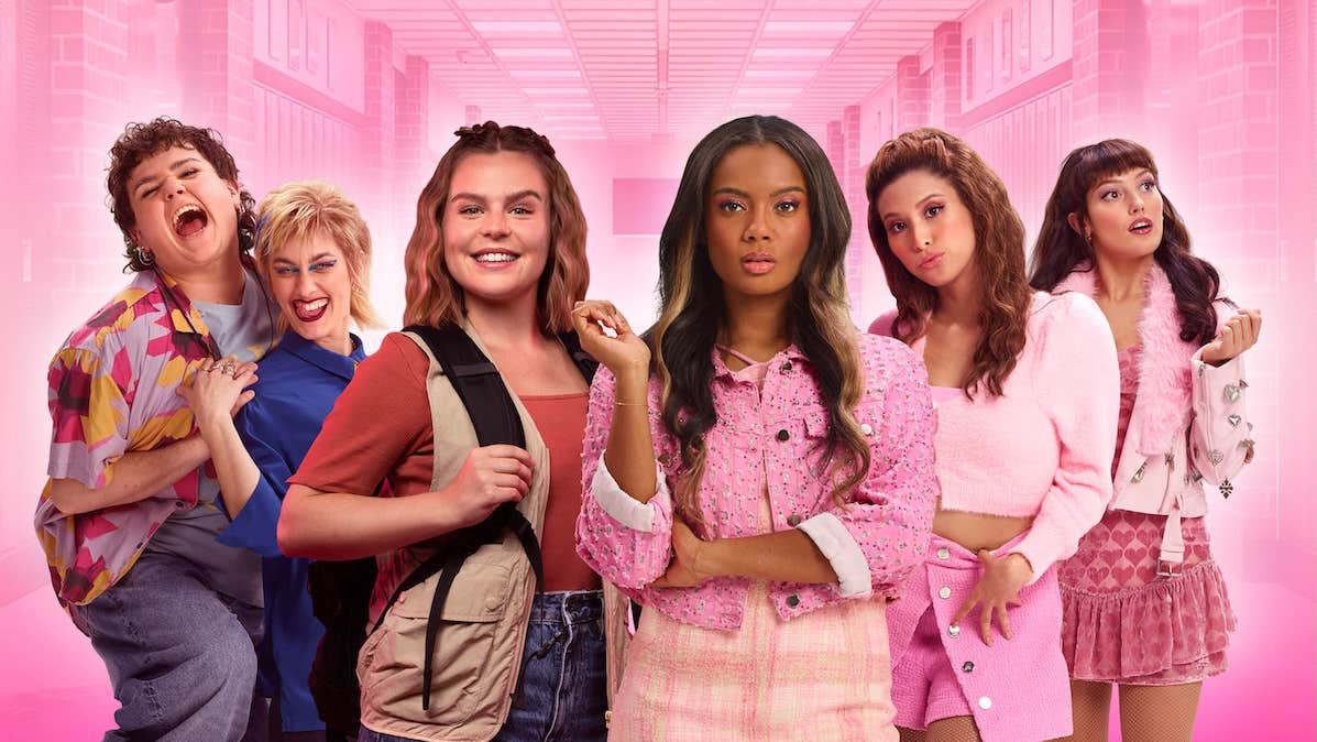 A group of young women with varying facial expressions, mostly wearing pink shades
