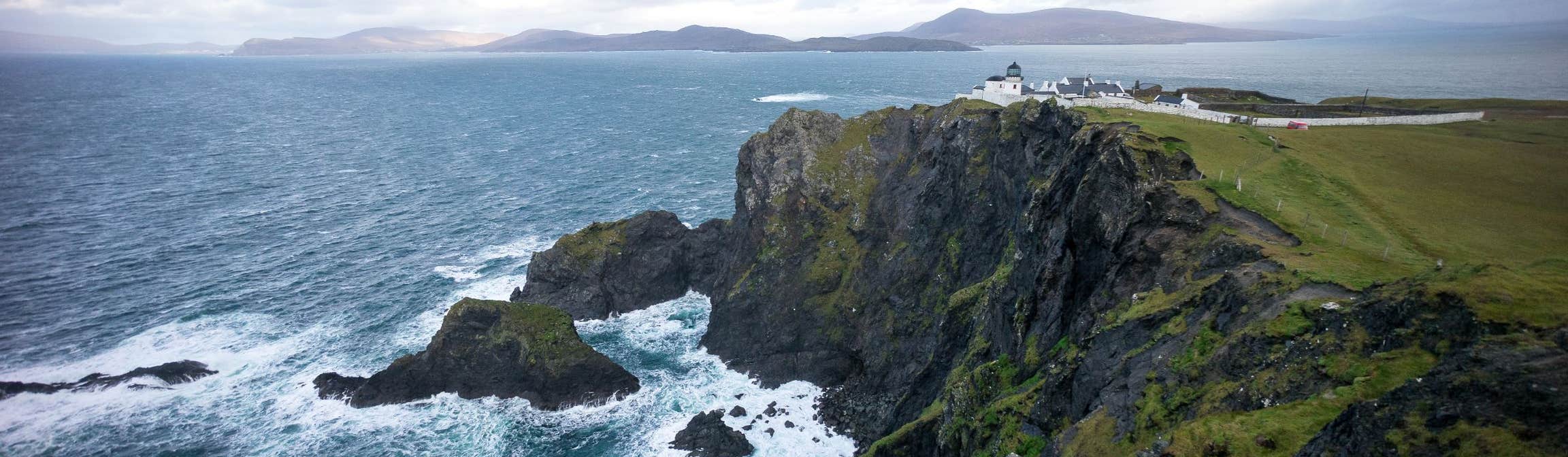 A lighthouse on the edge of a cliff on Clare Island in County Mayo