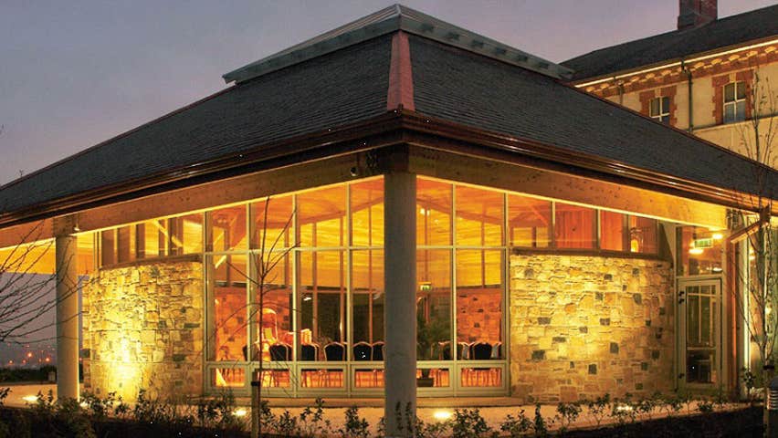 An exterior view of the Chapel by light showing the floodlit building