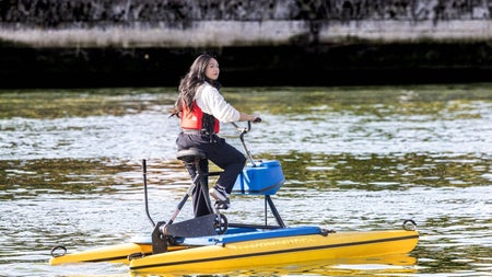 A lady using a hydrobike on the River Liffey