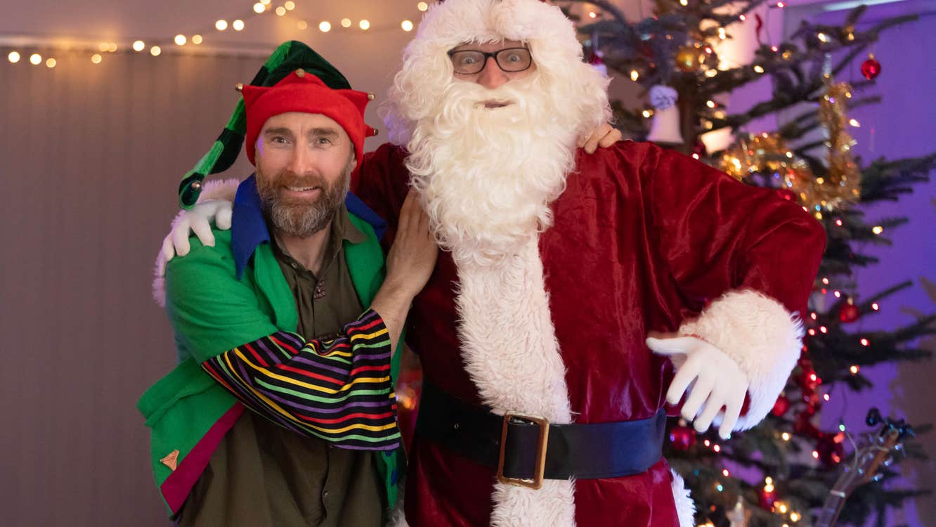 Santa and his Helper in front of the tree