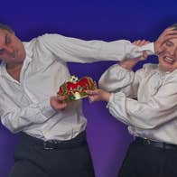 2 people both holding a small gold crown fighting against each other