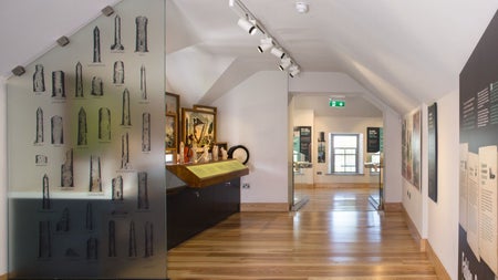 Exhibition in a room with white walls and a wooden floor
