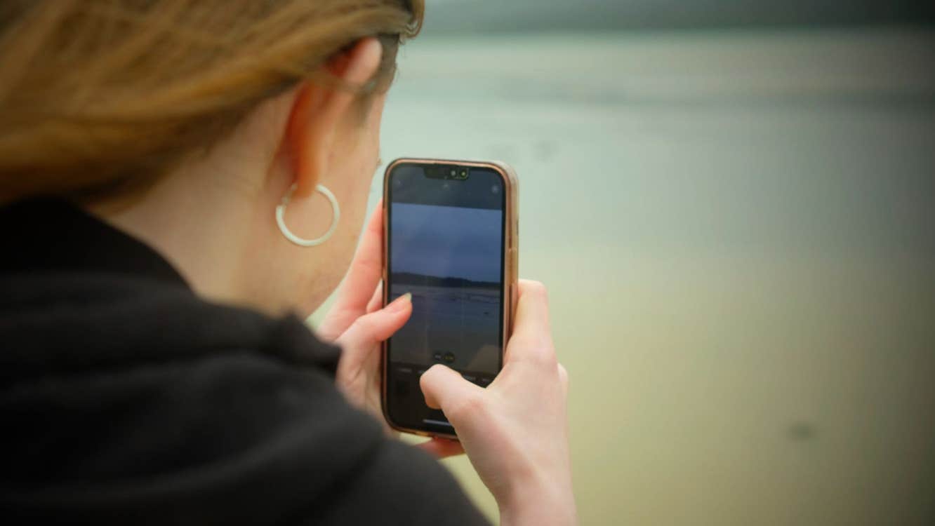 A person taking a photograph using their mobile phone
