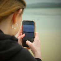 A person taking a photograph using their mobile phone