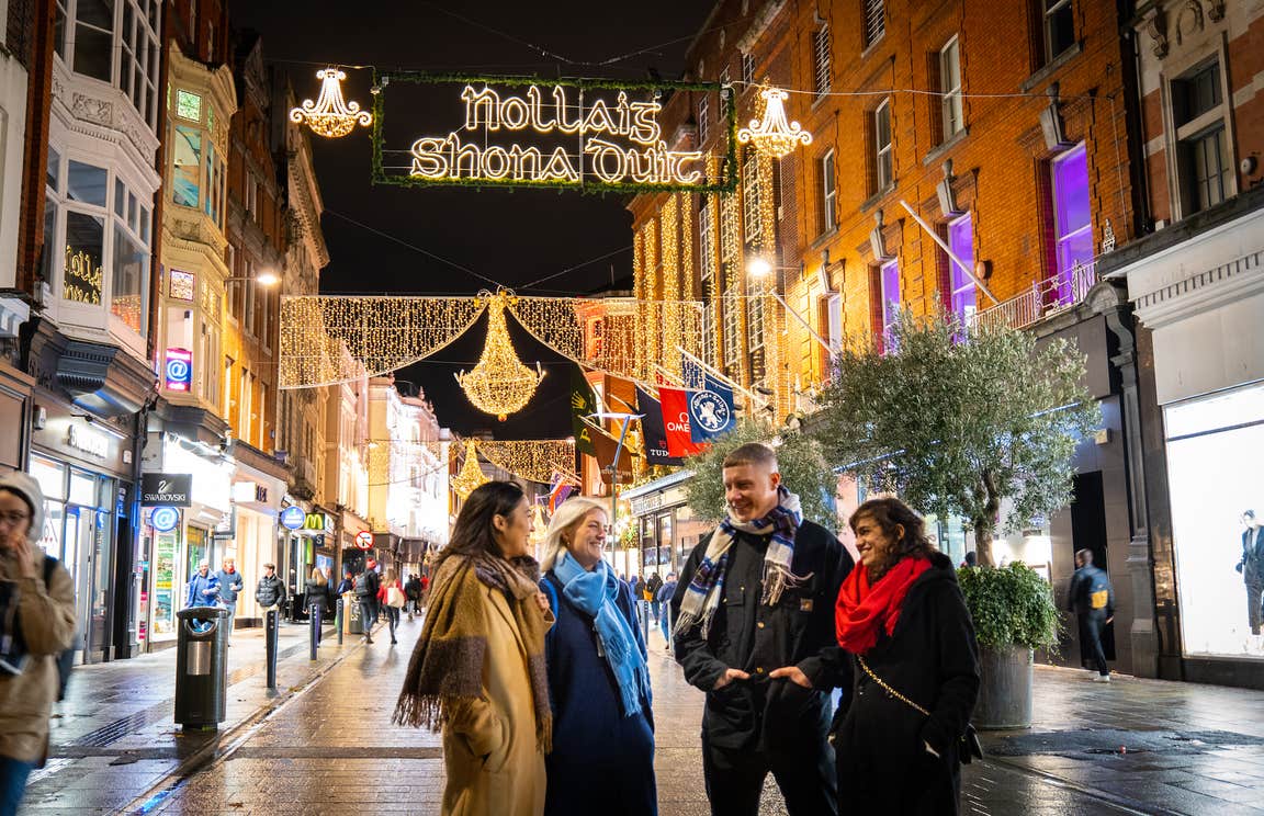 Friends walking down Grafton Street at Christmas.