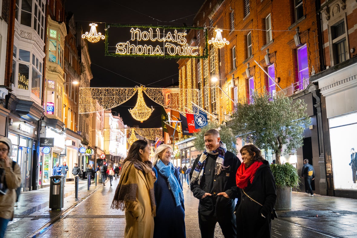 Friends walking down Grafton Street at Christmas.