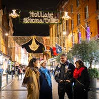 Friends walking down Grafton Street at Christmas.