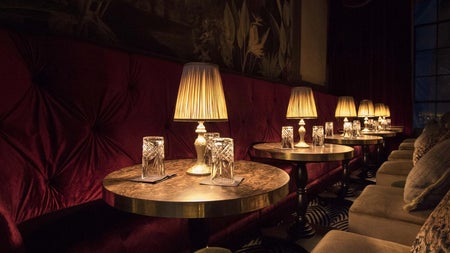 Seating by lamp lit tables at the Stella Cocktail Club