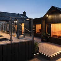 Lit saunas on a roof top at dusk