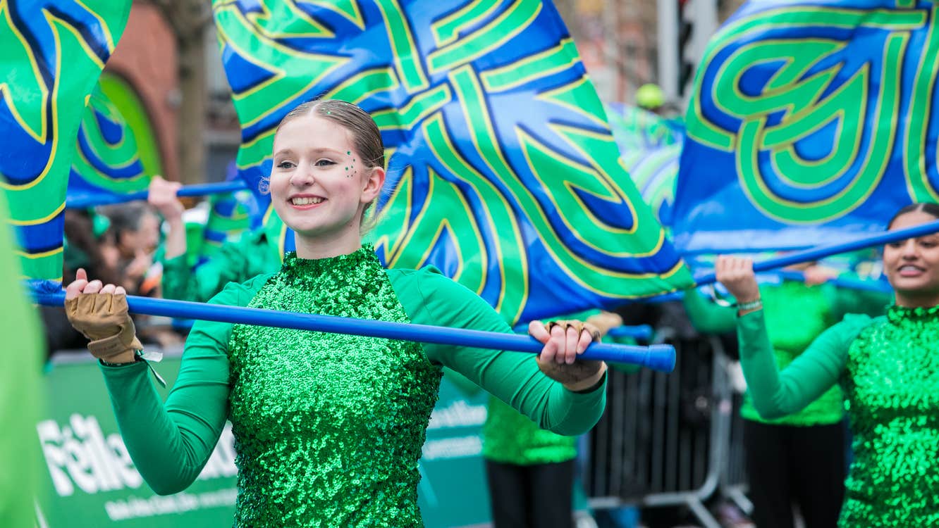 A young woman performing in a color guard at the St Patrick's Festival Dublin parade.
