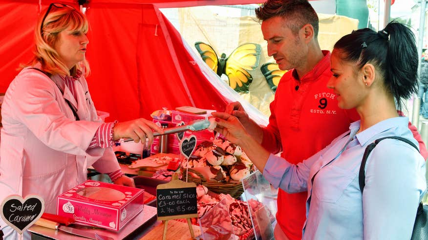 People trying food at a market in Waterford