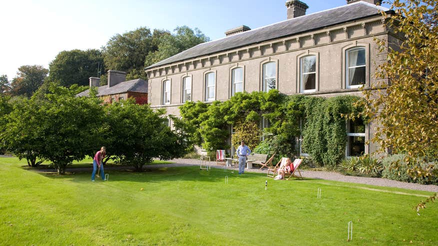 Family playing croquet on the lawn of Ballyvolane House.