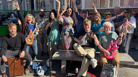 A group of people having fun with instruments on a Songwriter Tour