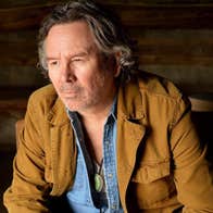 A man looking thoughtful, looking away to this right