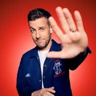 Comedian Chris Ramsey holding one hand out forewards