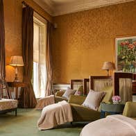 Three spa beds with blankets and cushions in a relaxation room