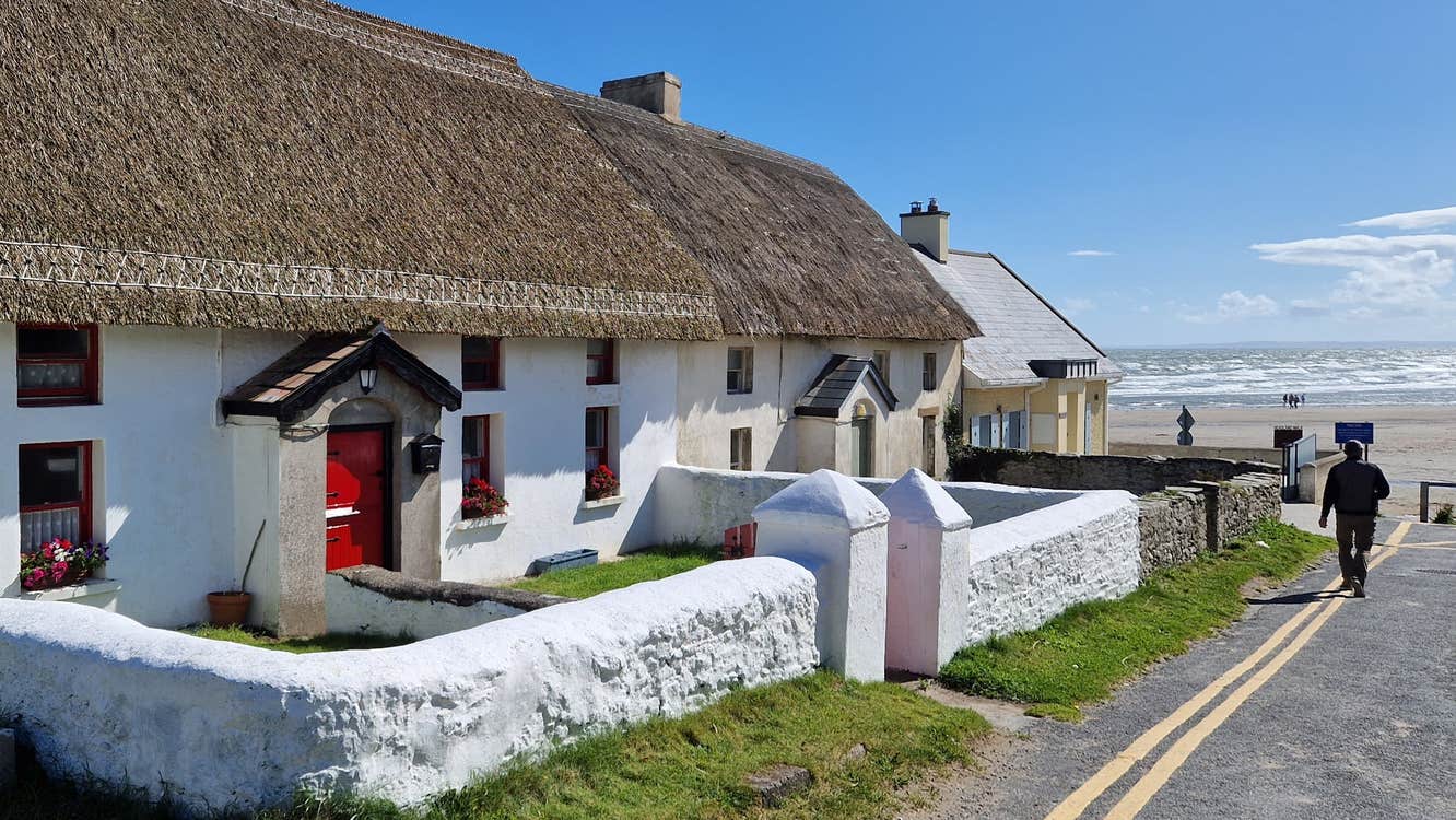 A pair of traditional thatched cottages and views of Clogherhead beach in County Louth