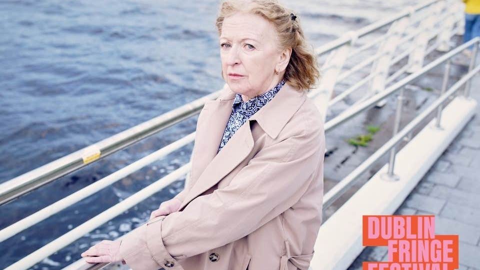 Mam and Love and Woo - Liam McCarthy. Joan Sheehy standing on a quay by a river