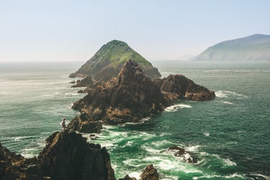 Rocky outcrops just off the coast with waves crashing against them