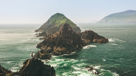 Rocky outcrops just off the coast with waves crashing against them