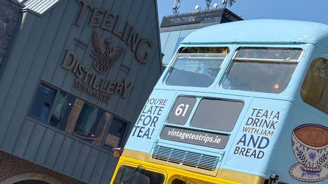 Exterior of Distillery with Vintage Bus in foreground.