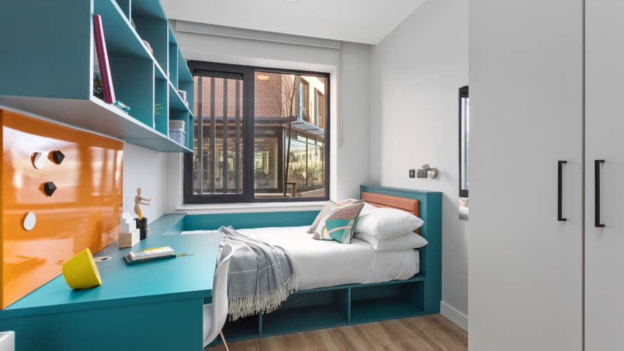 Bedroom with white sheets and seating area