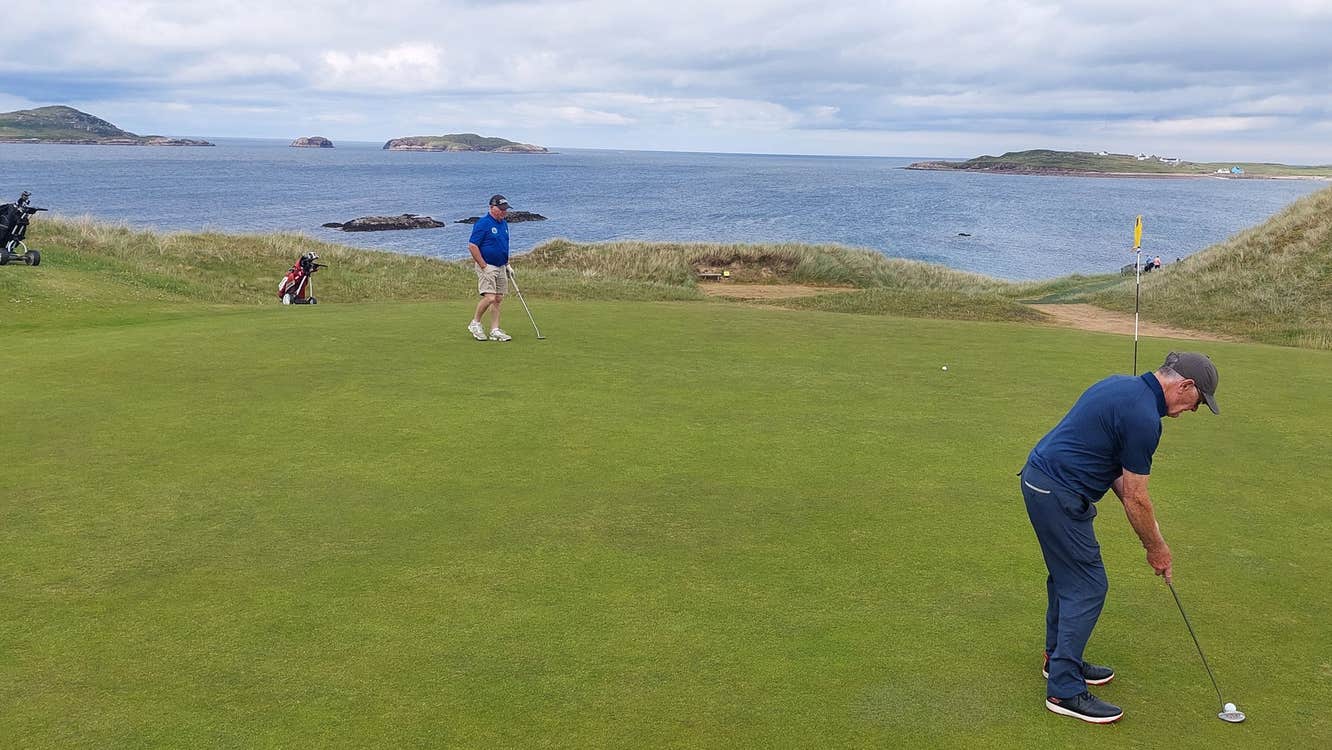 Two golfers playing golf at Gweedore Golf Club