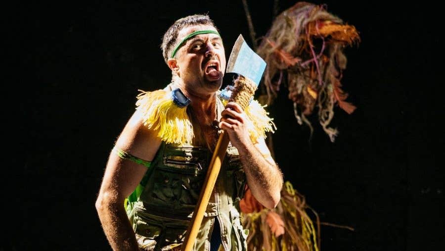 Image of man on stage holding an axe