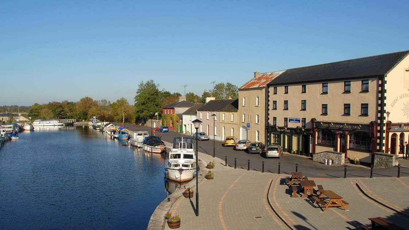 An image of the small tranquil village of Cloondara with the boats docked in the harbour
