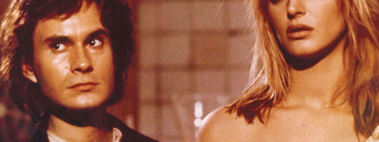 A young man and woman are staring intently at something.