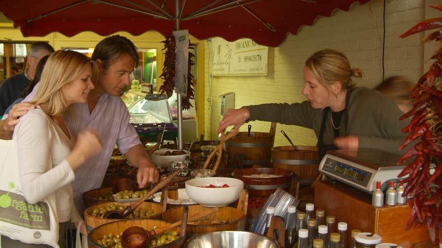 A couple buying food at a farmer's market.