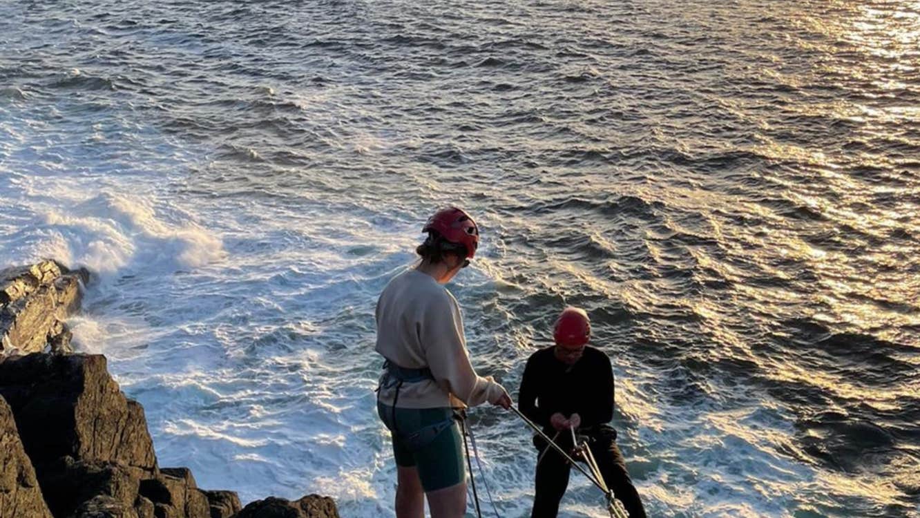 Abseiling from cliff face