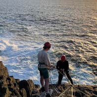 Abseiling from cliff face