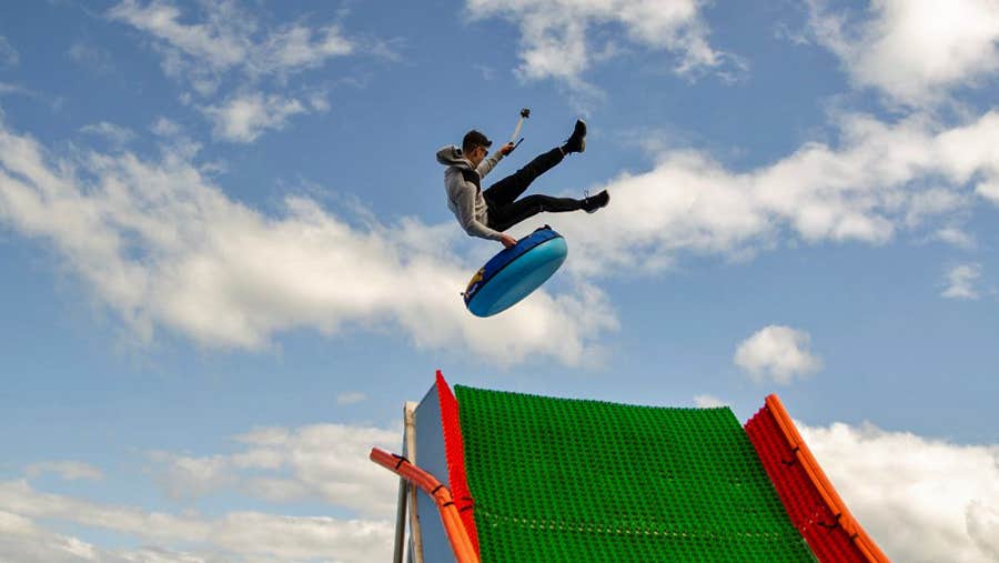 A man jumping while tubing and recording it with a device
