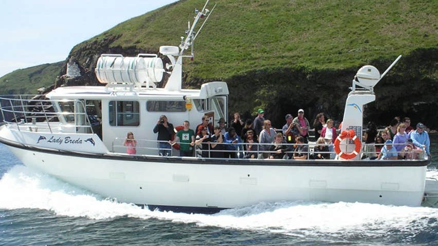 A boat with passengers heading out to sea