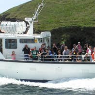 A boat with passengers heading out to sea