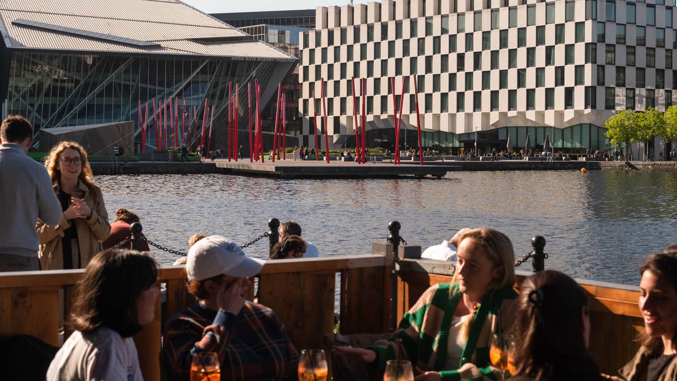 A group of people enjoying drinks in the outside seating area of Charlotte Quay Restaurant